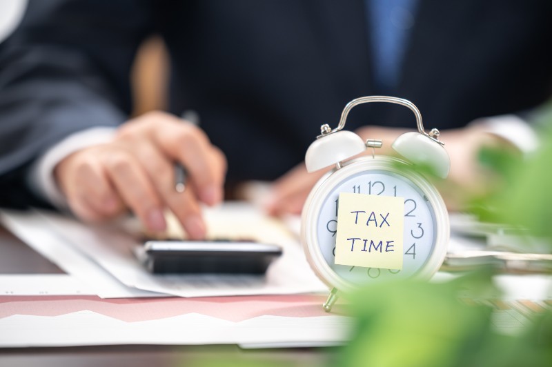 Alarm clock with tax time note-Year-End Tax Planning