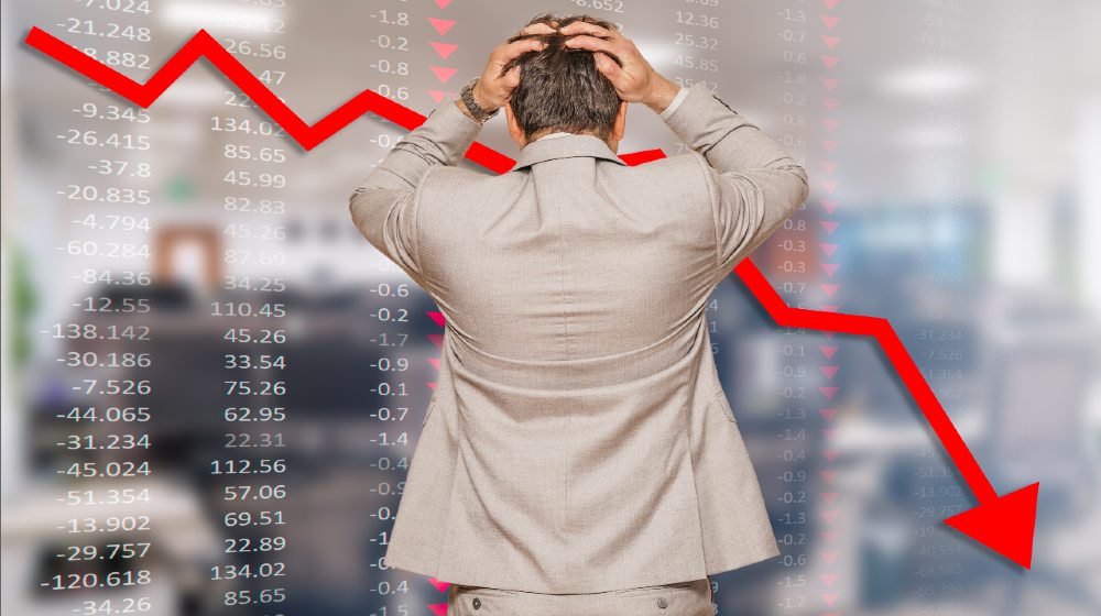Back view of middle age businessman pulling his hair out as his business falling during recession-Stocks Pull Back-ss-featured