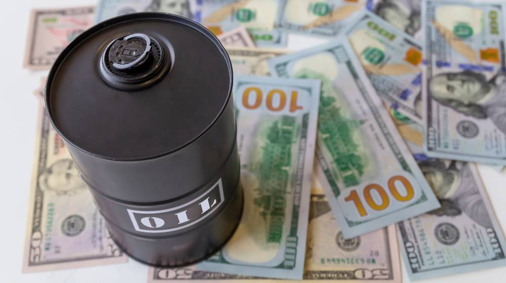 Barrel of oil on a background, american dollars background | Global Tensions in Europe and Middle East Push Oil Prices Up | featured