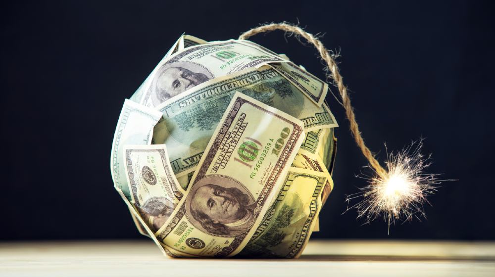 Big bomb of money hundred dollar bills with a burning wick. Little time before the explosion | Is Inflation The New Market Boogeyman? Experts Weigh In | Featured