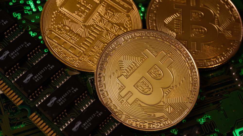 Bitcoin crypto currency comemorative coin on motherbord. | bitcoin etherem