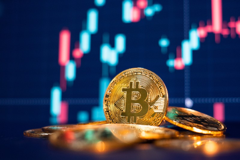 Bitcoin gold coin and defocused chart background-Bitcoin Prices