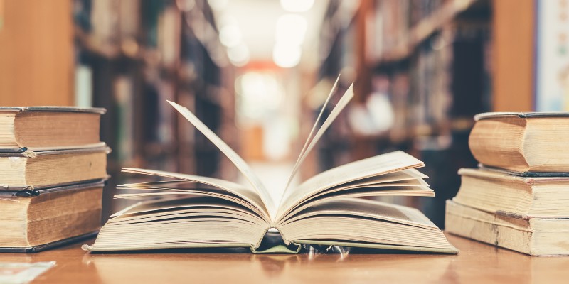 Book in library with old open textbook-Education of an Educator