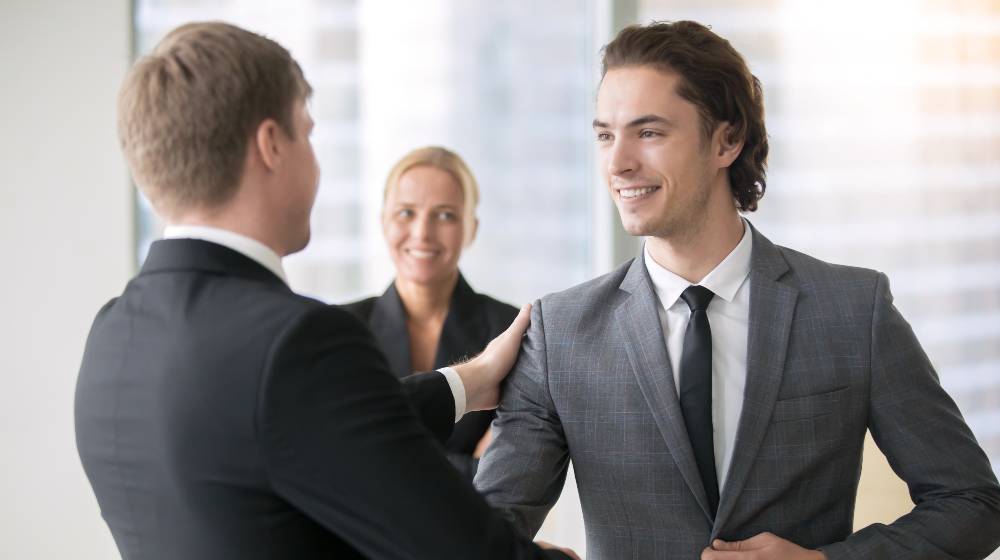Boss promoting male subordinate | Wage Growth Slowing Down As More Workers Are Signing Up | featured
