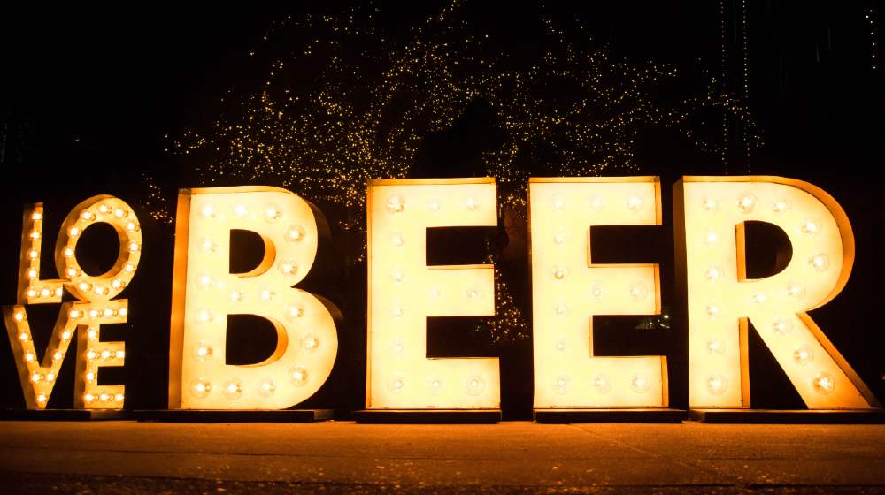 Brewery Lights at the Anheuser-Busch Budweiser Tours with huge love beer sign | Anheuser-Busch To Give Free Beer Once US Vax Rate Hits 70% | Featured