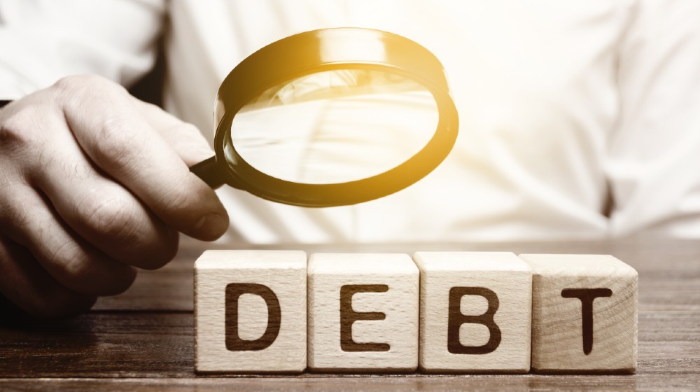 Businessman explores debt. Study of the structure of debt | All About Cleaning Up Your Credit & Choosing the Right Service | featured
