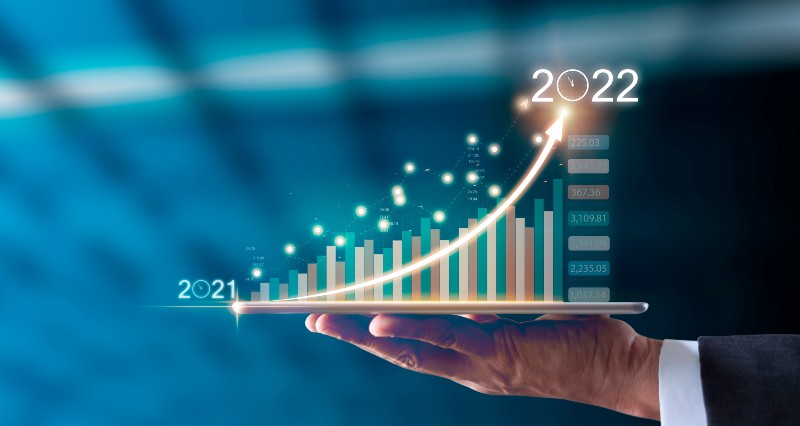 Businessman hand holding tablet showing graph economic growth target success from 2021 to 2022 | Financial Trends
