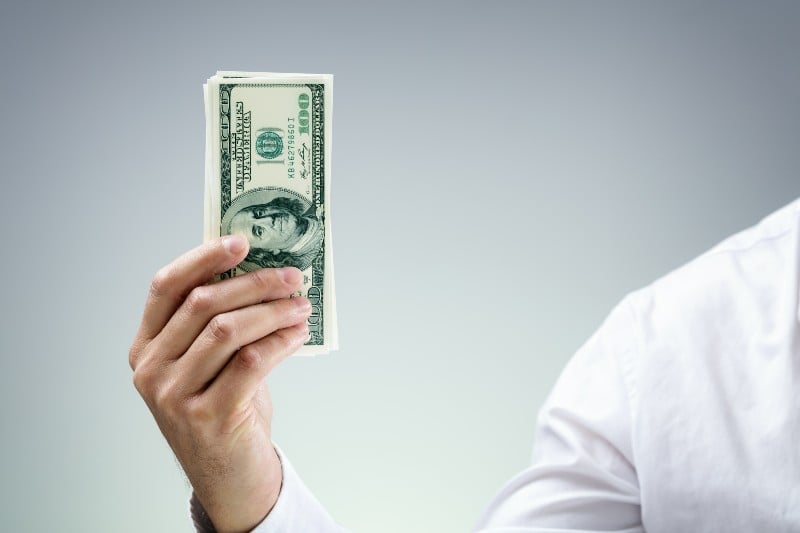 Businessman holding one hundred dollar bills concept for paying-Venture Capitalist