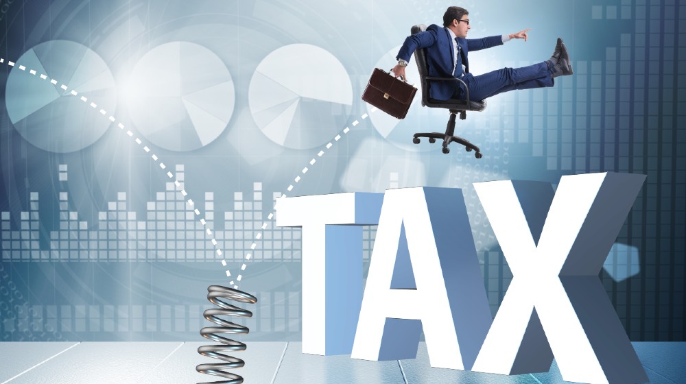 Businessman jumping from spring in business concept | Biden Coming After Tax Loopholes For The Ultra-Rich | Featured