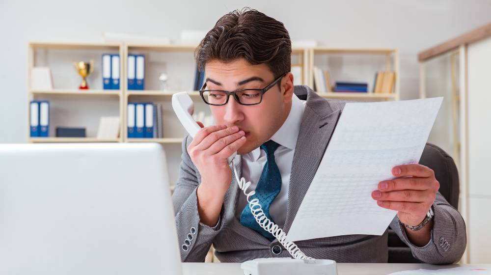 Businessman leaking confidential information over phone | Fed Officials to Face Probe for Possible Insider Trading | featured