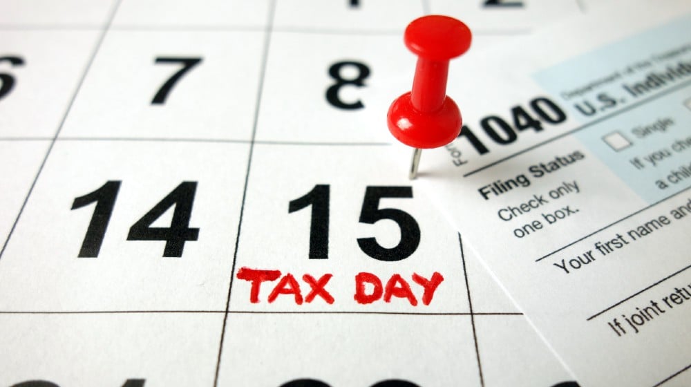 Calendar showing date April 15 2020 with 1040 form, tax day in USA-tax day-ss-featured