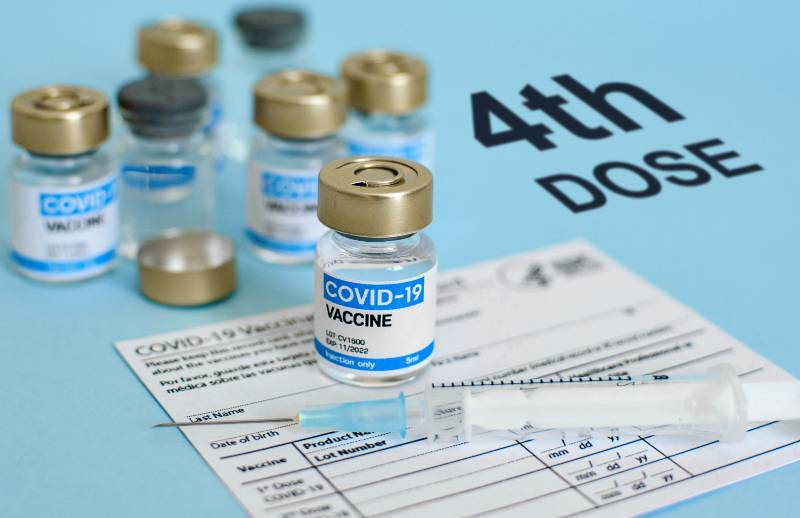 Close-up image of vaccine vial and syringe on CDC covid-19 vaccination record card Fourth | Fourth COVID Booster Necessary, According to Pfizer CEO