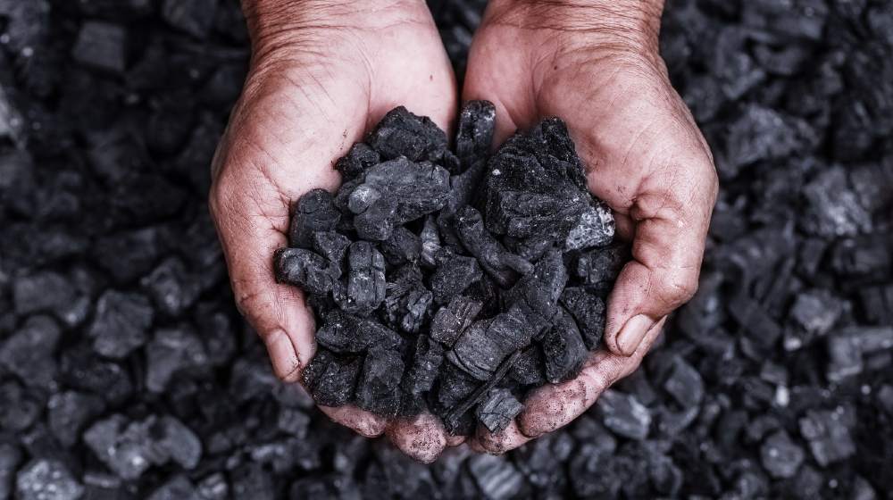 Coal mining coal miner in the man hands of coal background. Picture idea about coal mining or energy source | G7 Governments To End Support For Coal Power By 2021 | featured