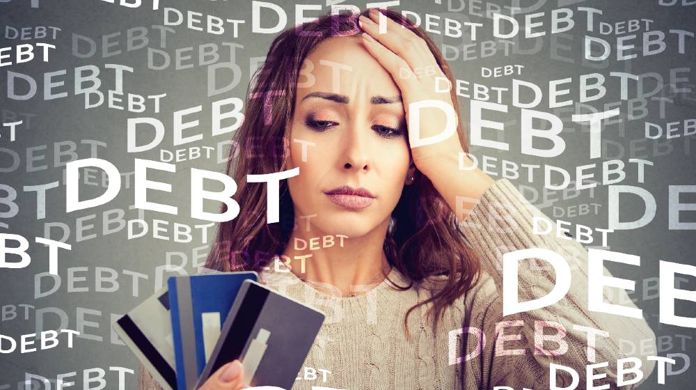 Concerned woman looking at many credit cards scared with huge amount of debt | How to Quickly Crush Credit Card Debt | featured