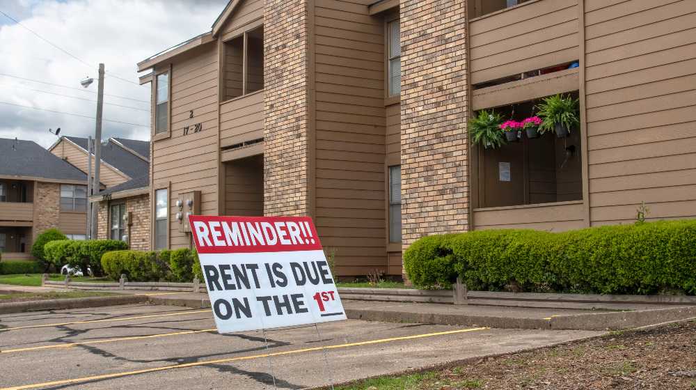 Despite the covid 19 pandemic shutdown, a sign in the parking lot of an apartment complex reminds renters that Rent is due on the 1st | Supreme Court Rejects Biden’s New Eviction Moratorium | featured