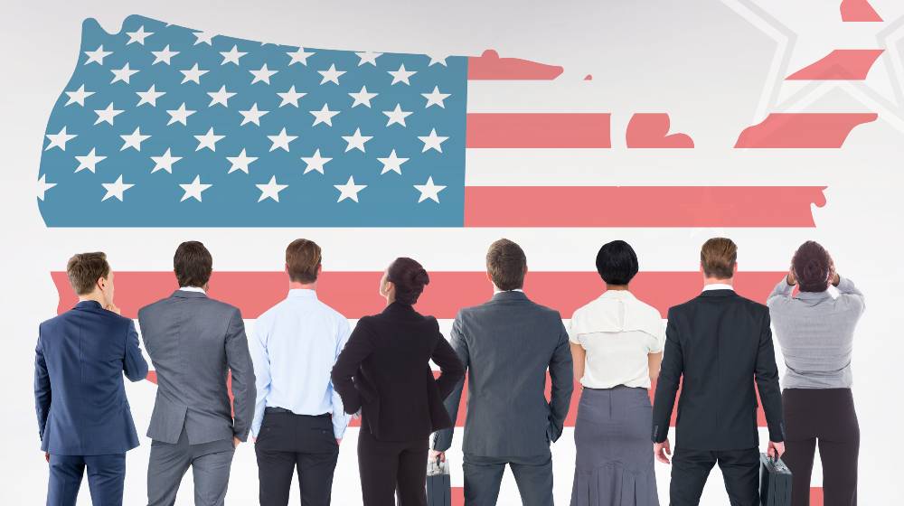 Digital composition of business people looking at American flag | The 4 Hottest Careers in the US This 2020 | featured