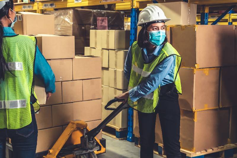 Factory industry worker working with face mask to prevent Covid-19-Supply Chain Crisis