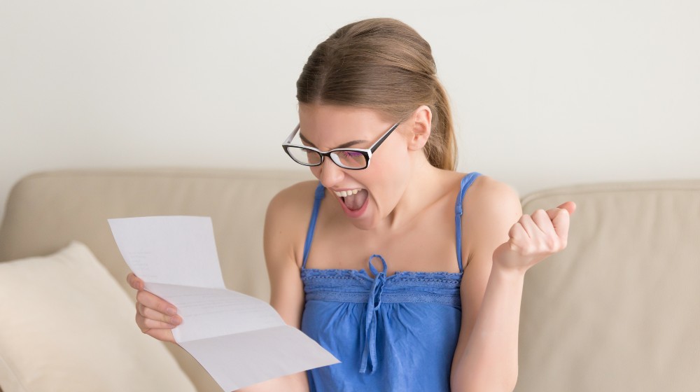 Female job applicant happy after receiving work invitation letter | Navient Ordered To Cancel $1.7 Billion Worth of Student Debts from 66,000 Borrowers | featured