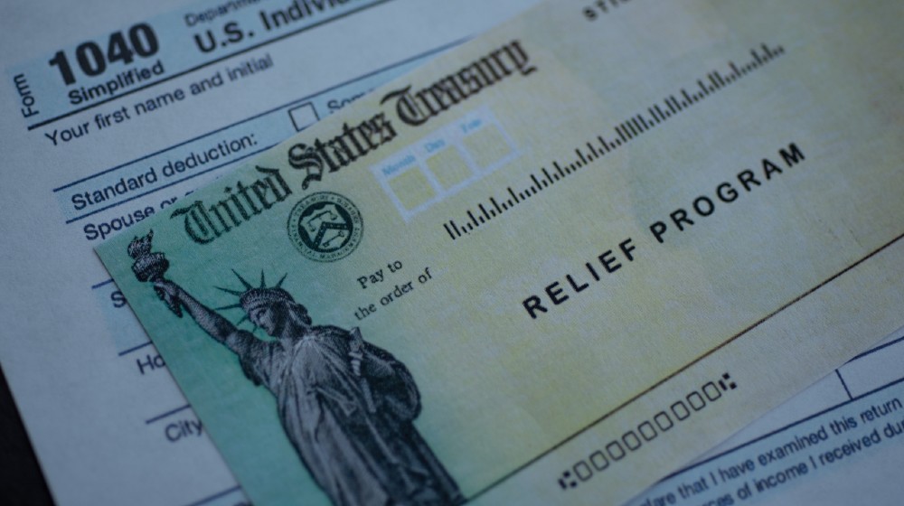 Form 1040 U.S. Individual Income tax return next to the Stimulus Check Relief program-Pass Stimulus Plan-ss-featured