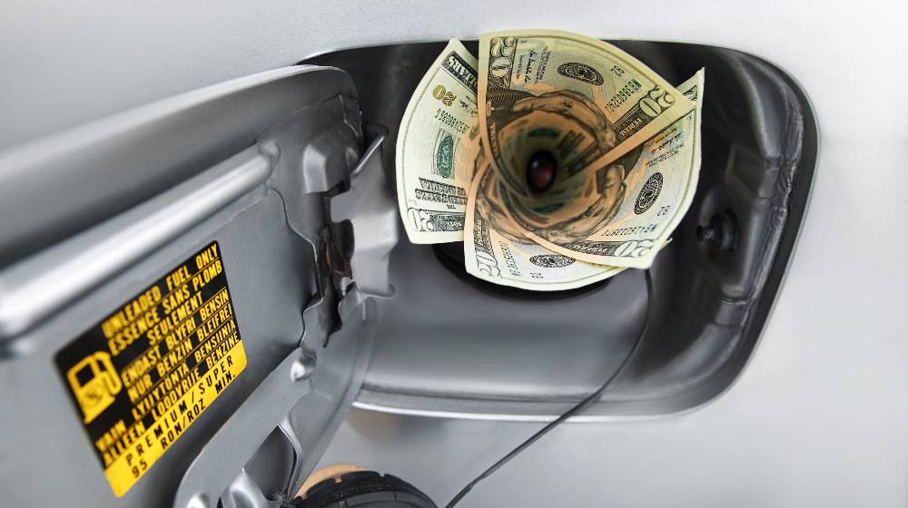 Fuel tank filled with money, symbolizing the high cost of fuel | US Gas Prices Hit Record of $4.17 Average Price per Gallon | featured