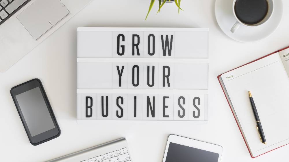 Grow your business words on office table with computer | Expand Your Business, Top Positions You Need to Fill! Ready to Grow? | featured
