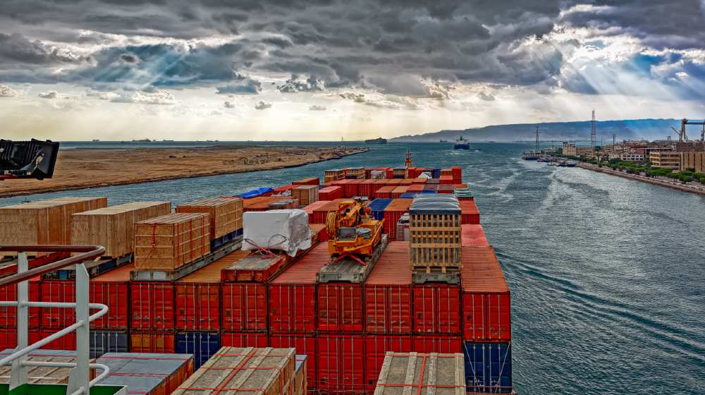 Industrial container ship passing through Suez Canal with ship's convoy-Suez Canal-ss-featured