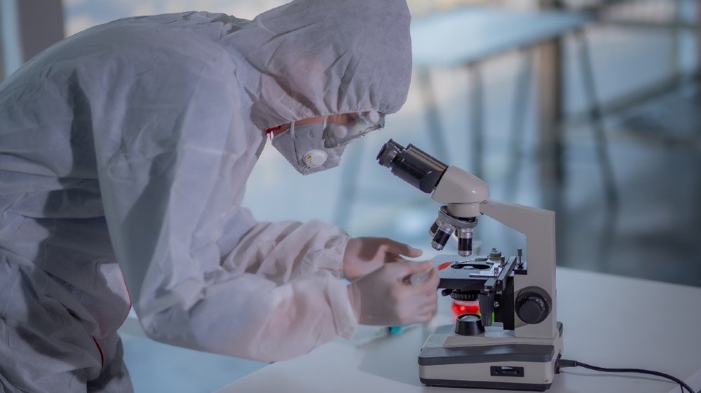 Male scientist testing experiment in a science lab where he holding scientific test tube full of chemical substance | How COVID-19 is spurring innovation in South Africa | Featured