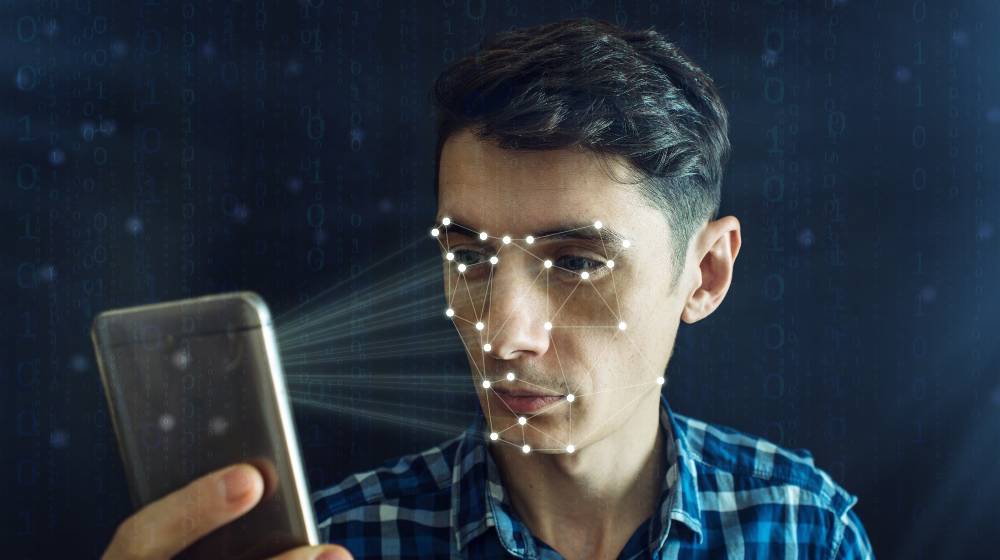 Man is trying to access the phone using the personal identification method of face recognition | Facebook To Shut Down Its Facial Recognition Program | featured