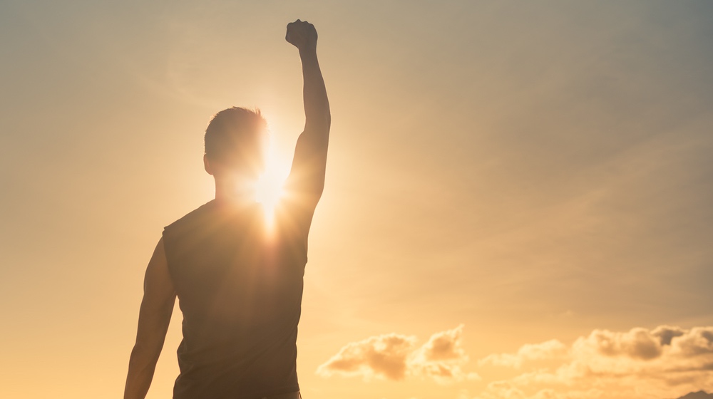 Man, power, victory, winning, hero concept. Strong young muscular male with fist in the air. | smart athlete