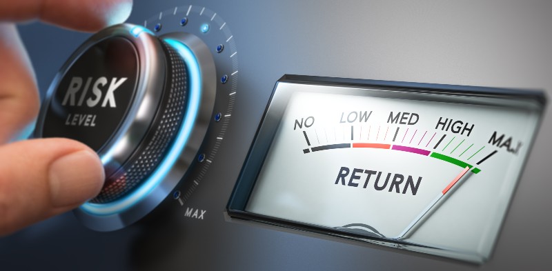 Man turning risk selector button to the medium position | How Risky Should You Be With Your Investments