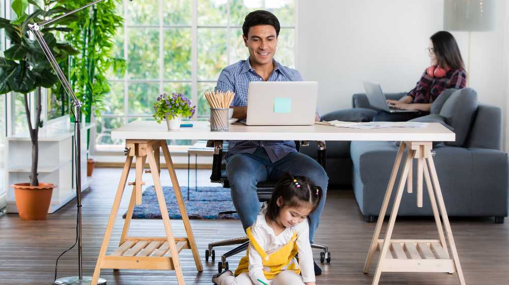 Mixed race family sharing time in living room | 61% of Employees Prefer Working From Home Vs At The Office | featured