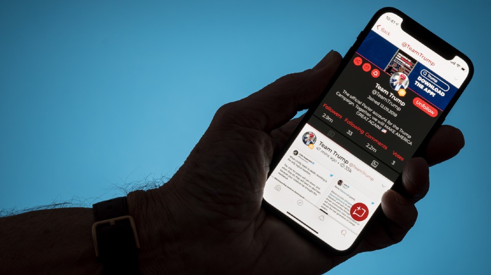 Modern phone with Parler social media app displaying Team Trump account in dispute with Twitter-Cut Ties With Parler-ss-featured