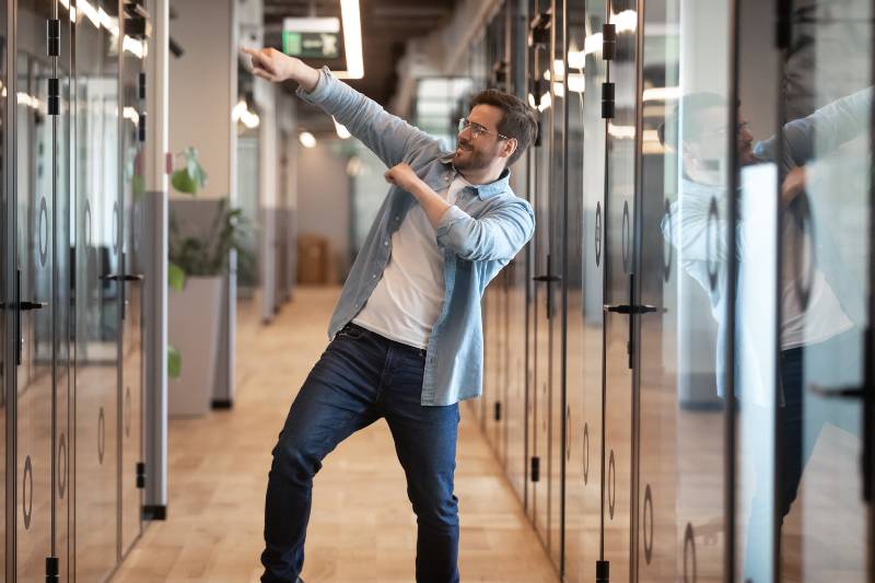 Overjoyed funny male employee have fun perform winner dance | Great Leaders