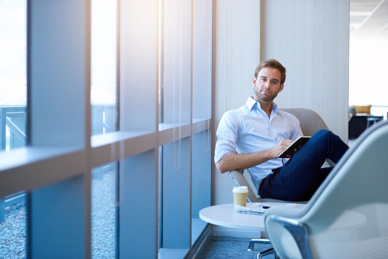Portrait of a positive young businessman sitting in a modern corporate environment-Property Being Stolen