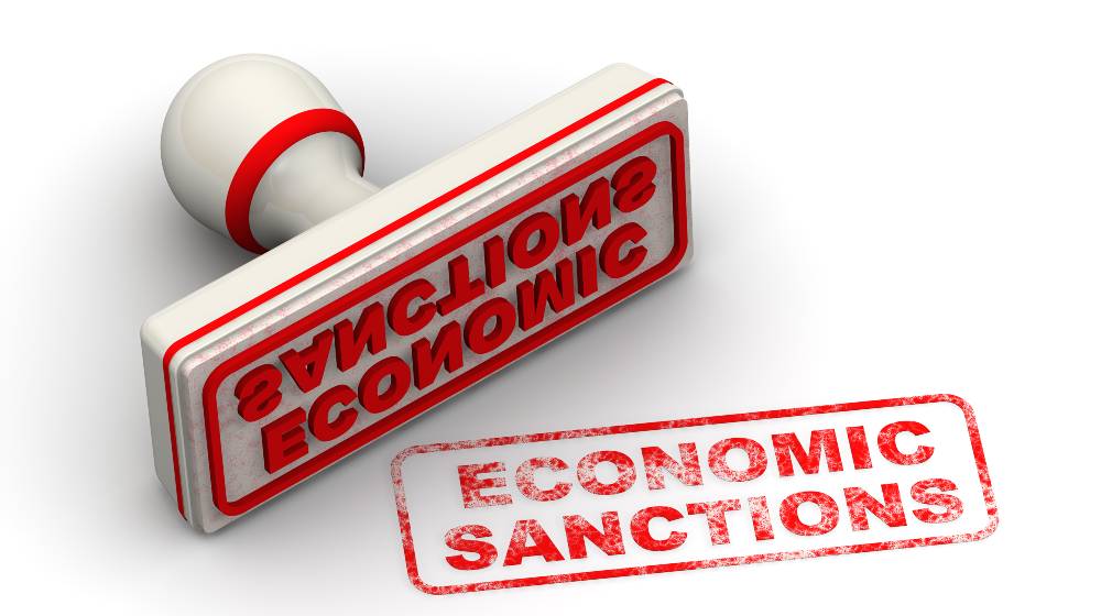 Red seal and imprint ECONOMIC SANCTIONS on white surface | Russia Vows To Strongly Retaliate Against To US Sanctions | featured