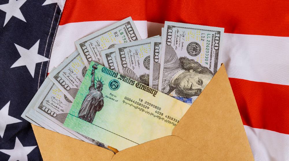Senate stimulus deal includes individual checks virus economic stimulus plan USA dollar cash banknote on American flag Global pandemic Covid 19 lockdown-$600 Stimulus Check-ss-featured