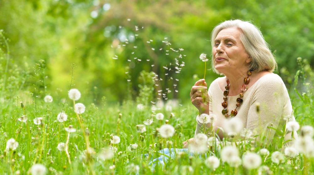 Senior woman in green park-ss-featured