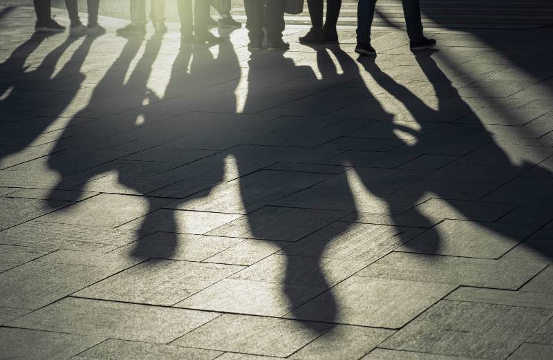 Shadows and silhouettes of people at a city during sunset | Overthrow Putin At All Costs