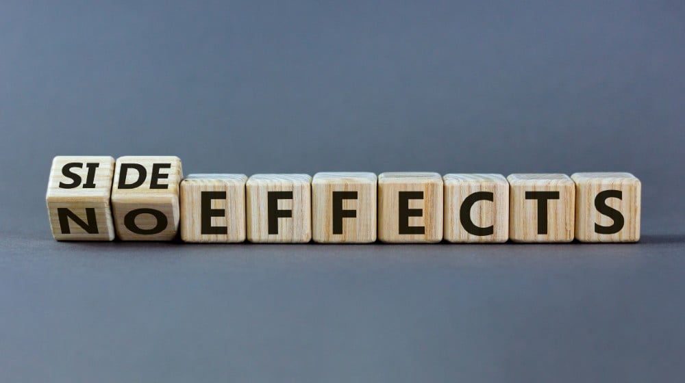Side or no effects symbol. Turned wooden cubes and changed words 'no effects' to 'side effects' | FDA To Add Heart Warning To Pfizer, Moderna Vaccines | featured