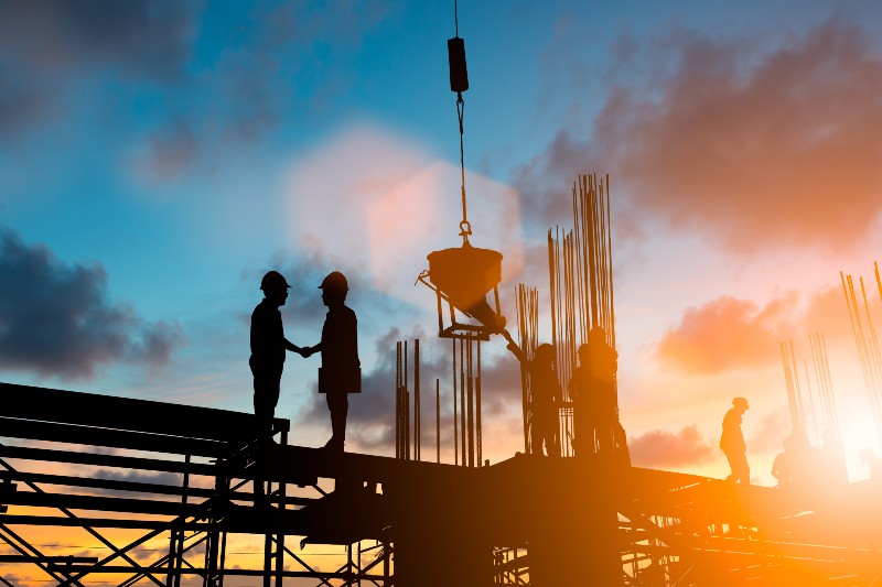 Silhouette businessmen shake hands finishing a deal-Infrastructure Deal