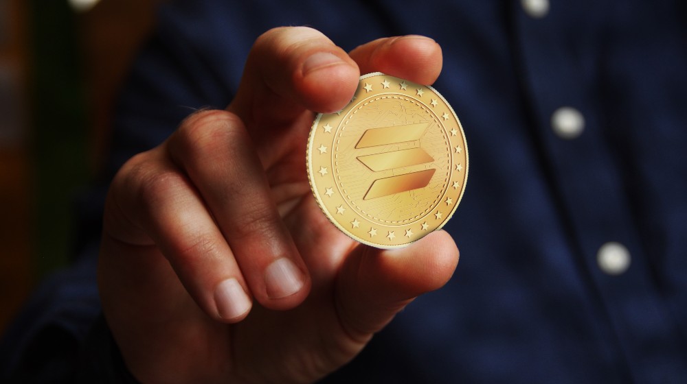 Solana altcoin cryptocurrency symbol golden coin in hand abstract | Solana, The New Crypto Kid on the Block | featured