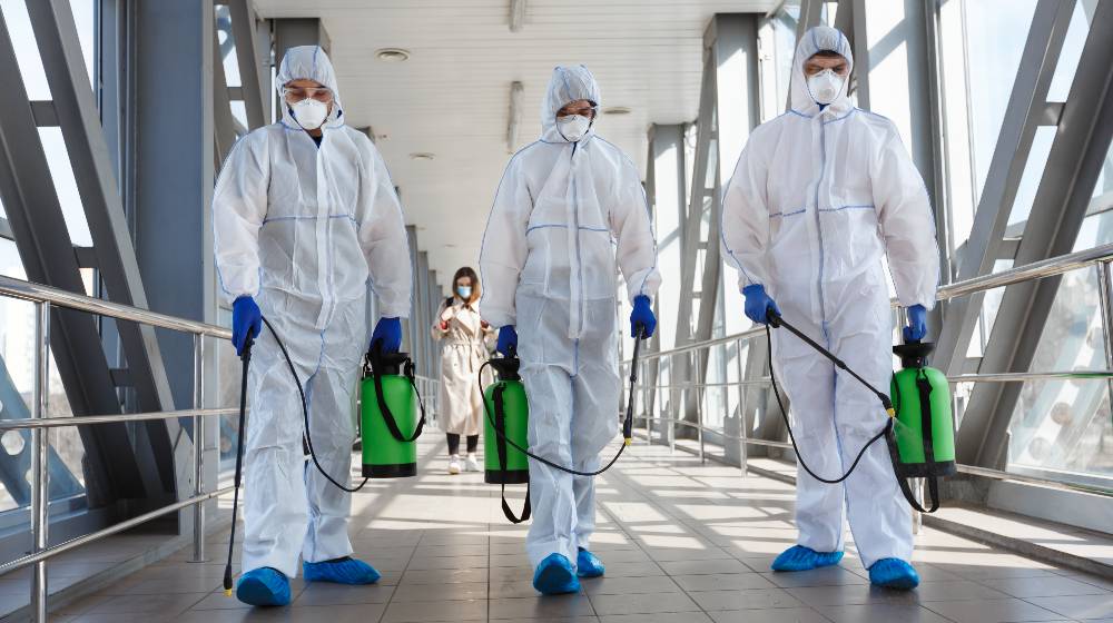 Specialist in hazmat suits cleaning disinfecting coronavirus cells epidemic, pandemic health risk | The Current Phase Of This Pandemic | featured