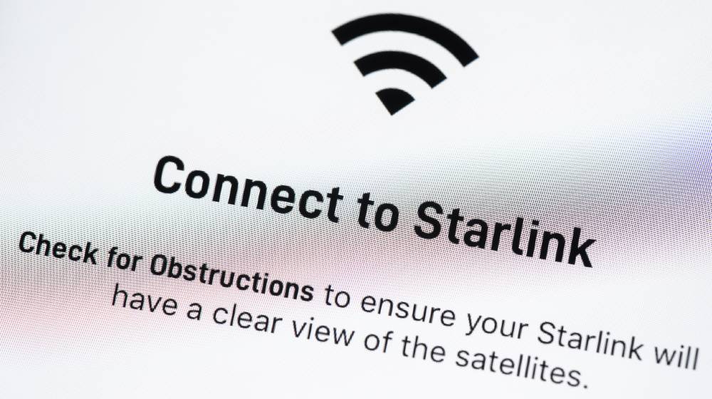Starlink app on Apple iPhone screen. Starlink is a satellite internet constellation being constructed by SpaceX | Elon Musk Says Starlink To Have Half Million Users By 2021 | featured