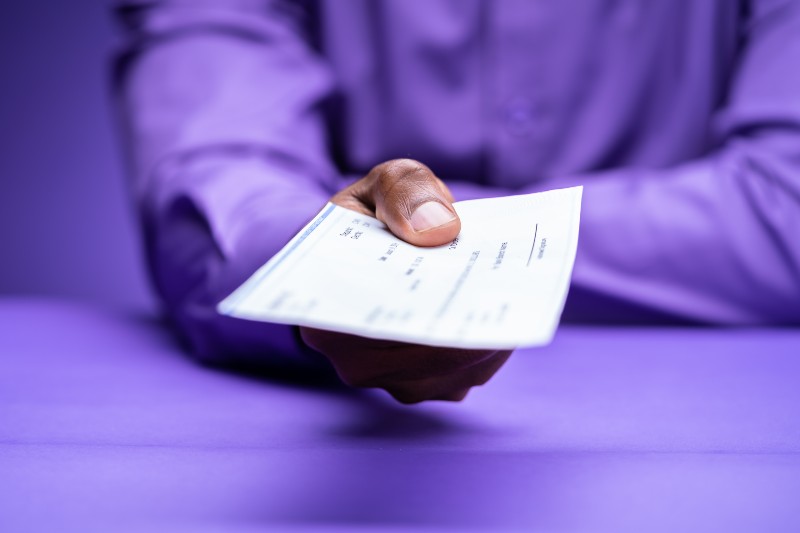 Stimulus Check And PPP Loan Payment Cheque In Hand | $100 Monthly Stimulus Checks, Anyone?