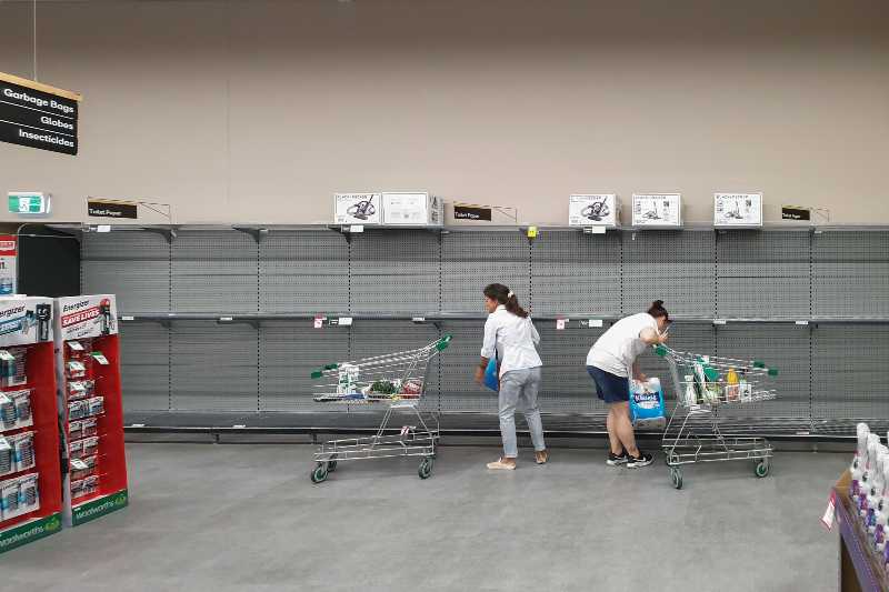 Supermarket empty toilet paper shelves amid coronavirus fears-empty shelves