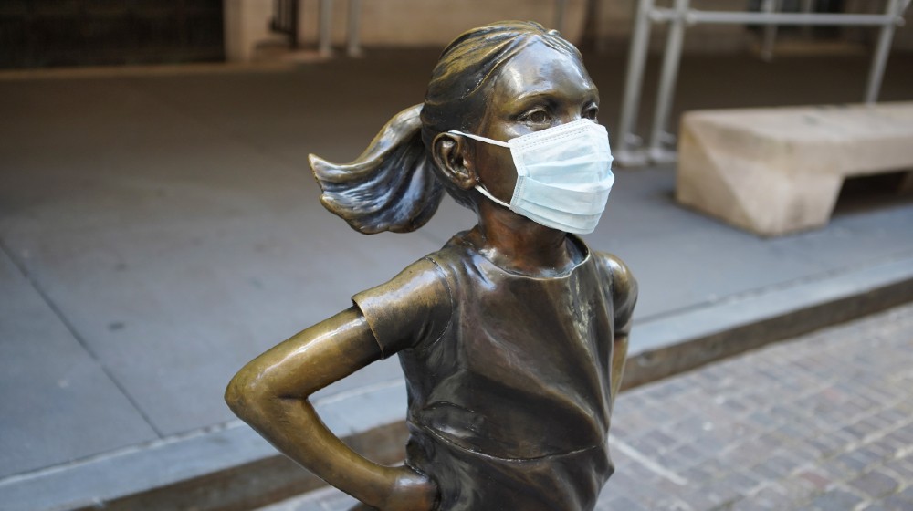 The Fearless Girl Statue in New York City wears a mask as the COVID-19 coronavirus spreads across the world-Wall Street Continue to Rise in 2021-ss-featured