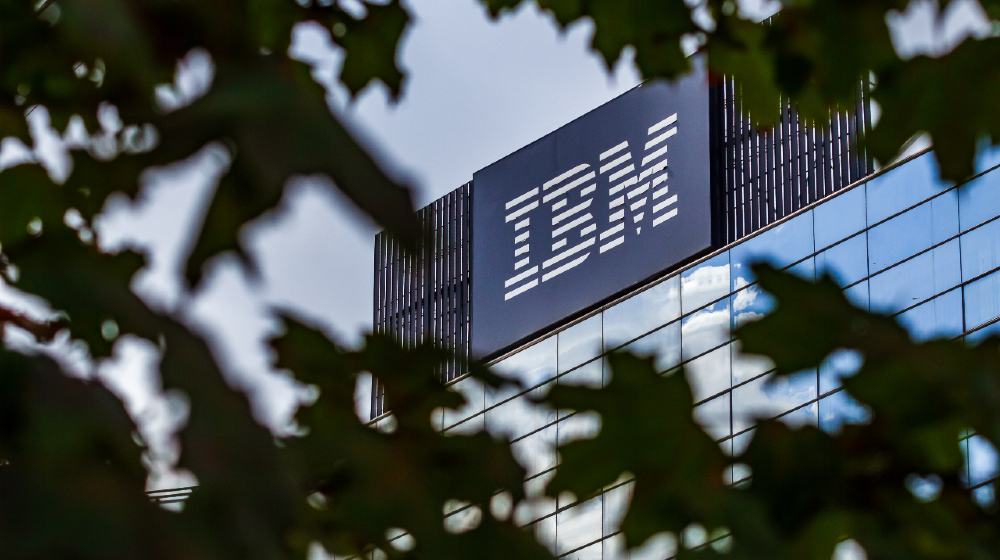 The IBM logo is seen on the top of the IBM GDC Romania headquarter building | IBM Retirement Fund Reduces Stock Position | Featured