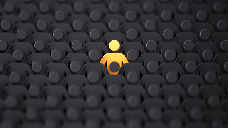 Unique color yellow human shape among dark ones. Leadership-Human Leadership