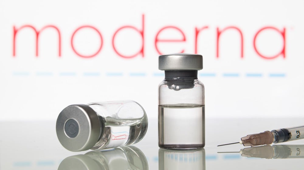 Vials and syringe with Moderna Inc logo | Moderna Working On A Combination COVID and Flu 2-in-1 Vaccine | featured