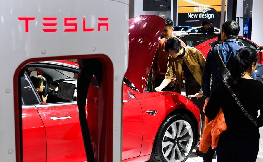 Visitors view a car from US electric car maker Tesla at Haikou New Energy Vehicle Exhibition in Haikou, south China's Hainan province, on Jan 10, 2019. [Photo/Xinhua]